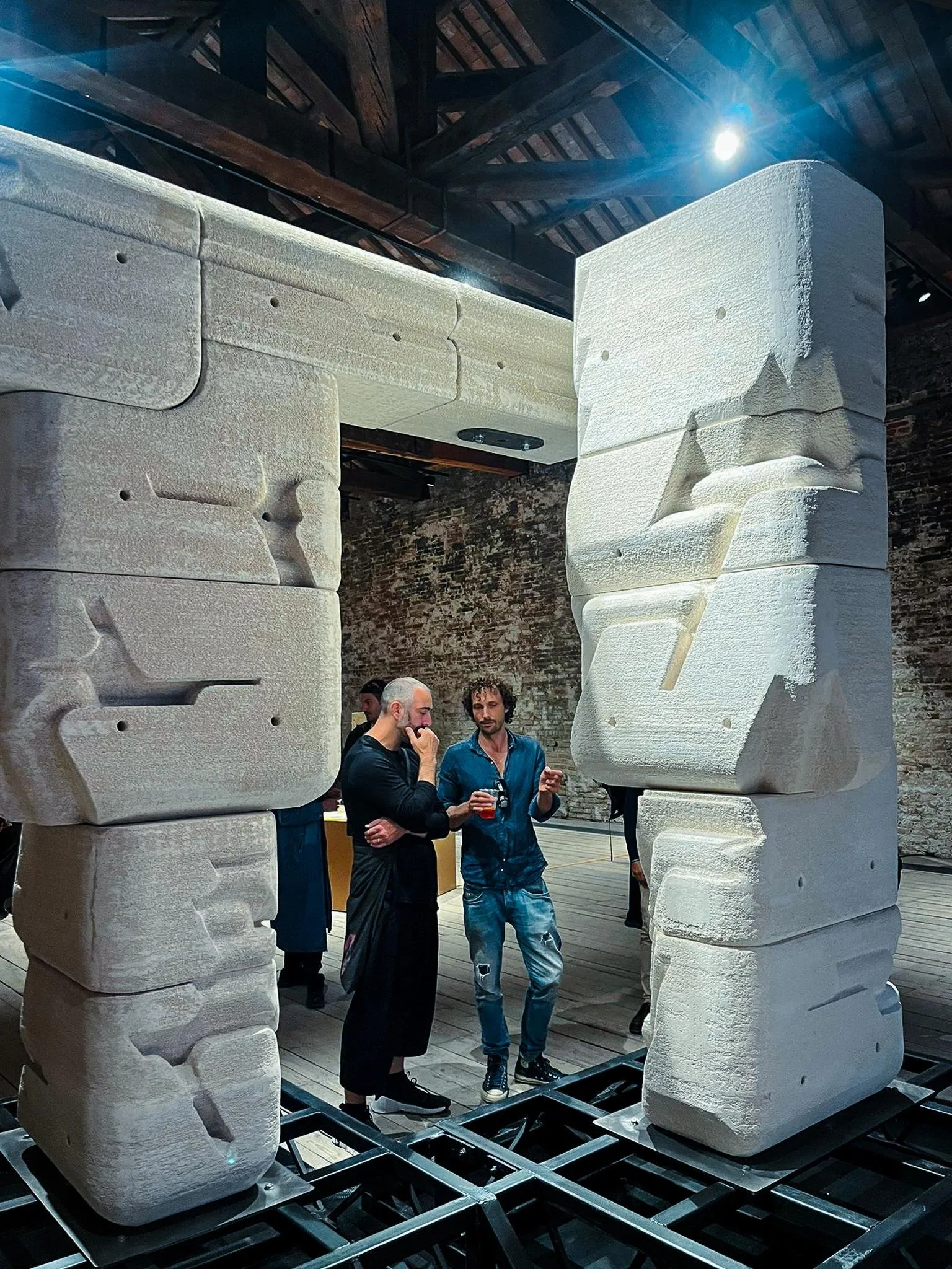 Printed stone columns with visitors for scale